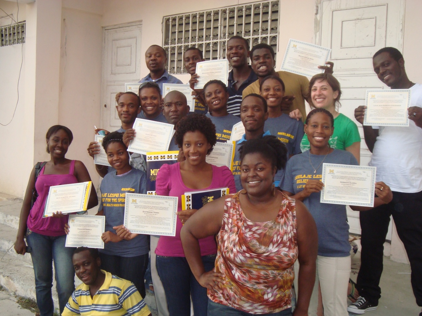 SLM staff receiving certificates of completion following training session