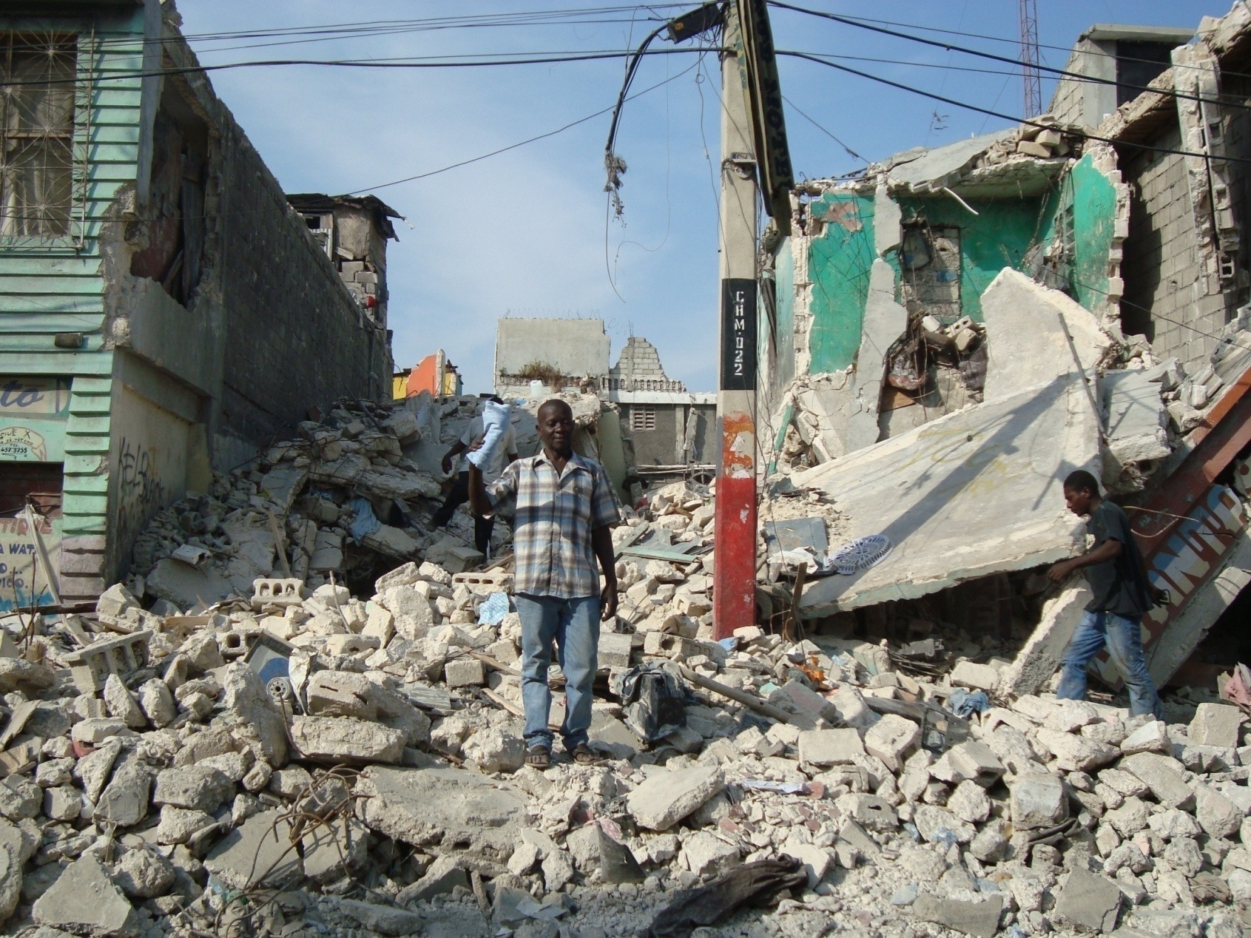 Resident of Port-au-Prince, Haiti standing in front of his demolished home following 2010 earthquake.