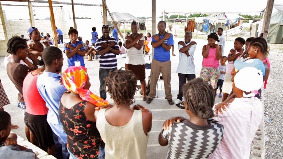 SLM lay mental health workers leading program participants in practicing a relaxation exercise.